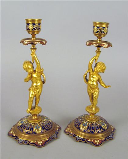 Appraisal: Pair of French figural gilt bronze and champleve candlesticks Each