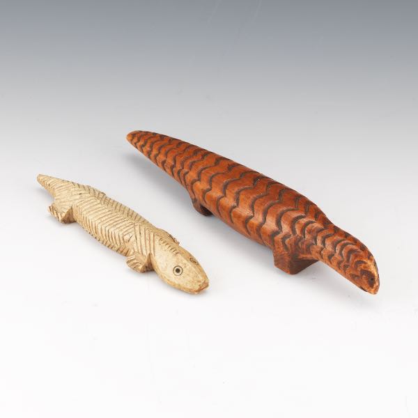 Appraisal: TWO AFRICAN CARVED FIGURINES Two lizards the larger with rust