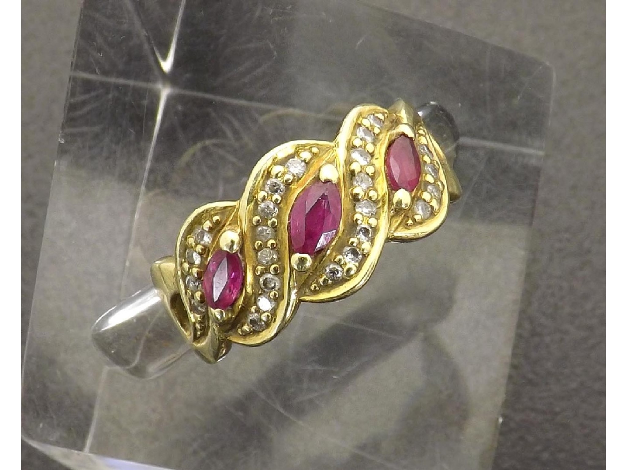 Appraisal: k ruby and diamond cross-over design band ring gm ring