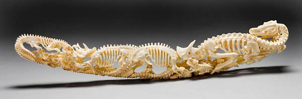 Appraisal: Fossil Walrus Ivory Carving of Dinosaurs Designed by Lee Downey