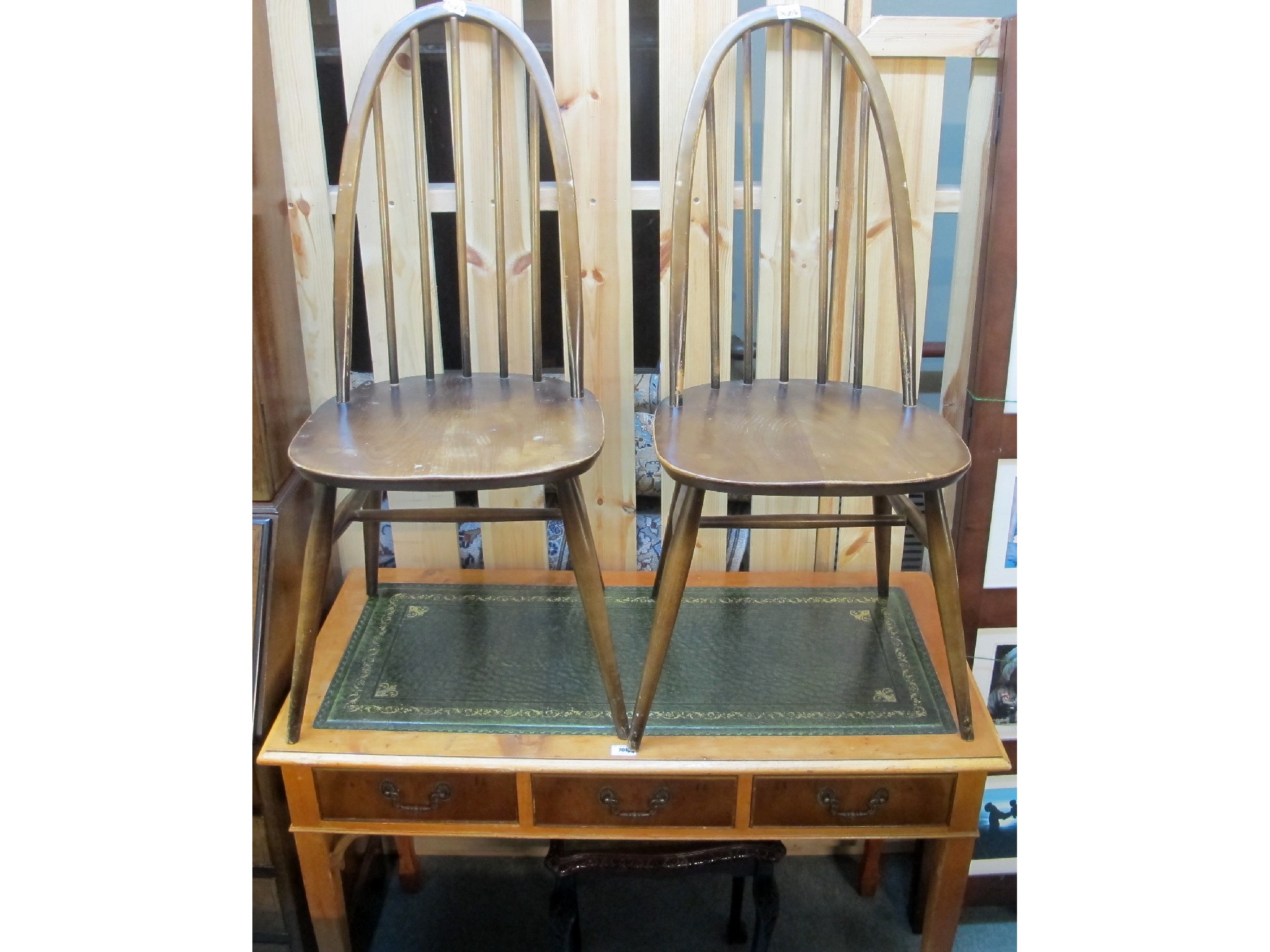 Appraisal: A leather topped three drawer table two Ercol style chairs