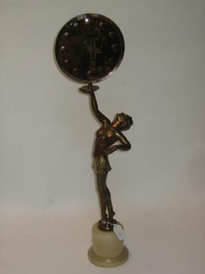 Appraisal: AN ART DECO SPELTER FIGURE modelled as a lady holding