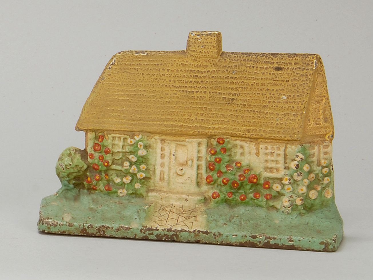 Appraisal: PAINTED CAST IRON DOORSTOP In the form of a cottage