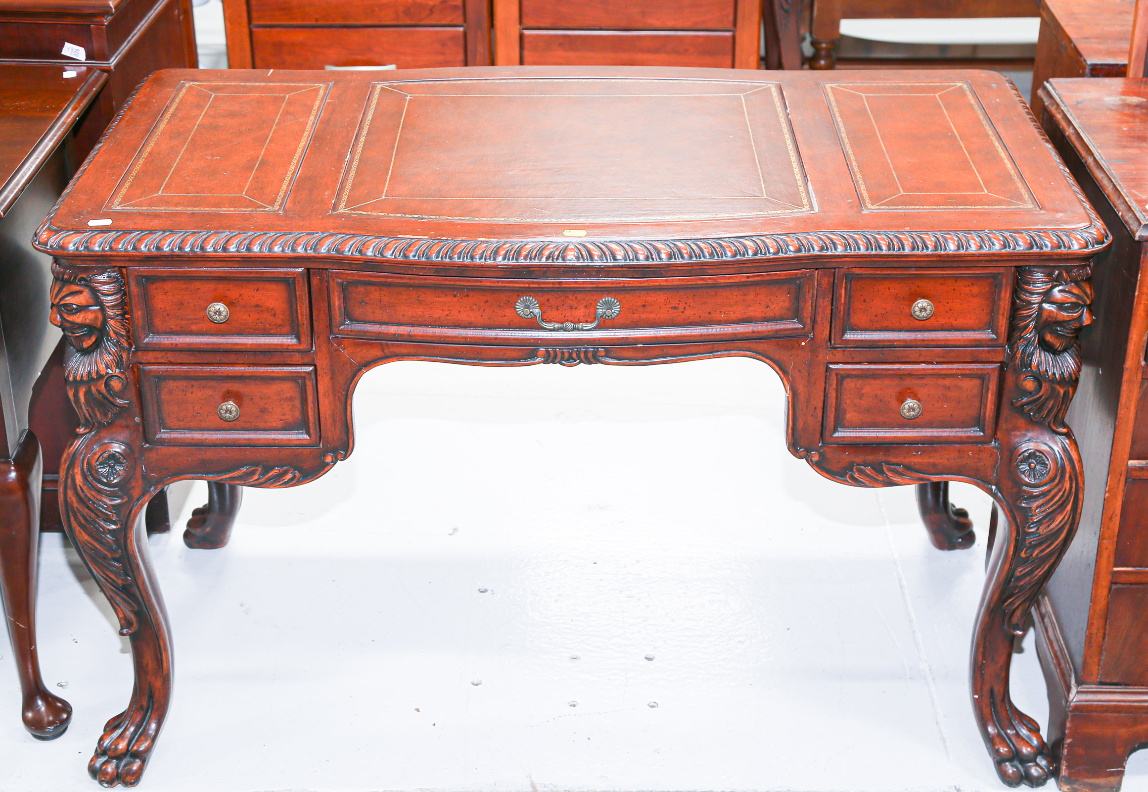 Appraisal: CHIPPENDALE STYLE MAHOGANY DESK Modern with inset leather panels on