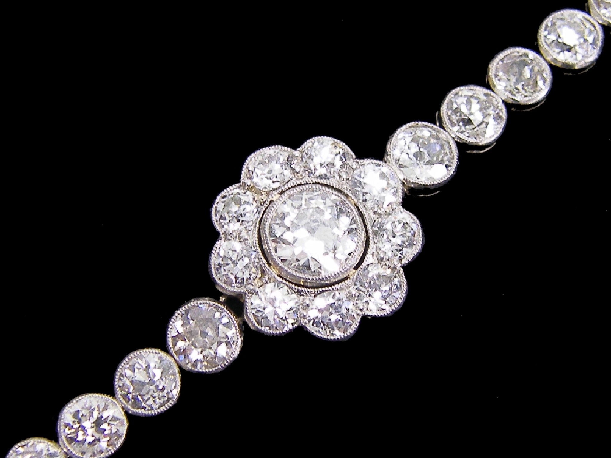 Appraisal: Fine platinum diamond bracelet the centre daisy cluster with a