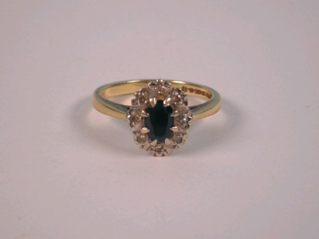 Appraisal: A sapphire and tiny diamond cluster ring to shank stamped