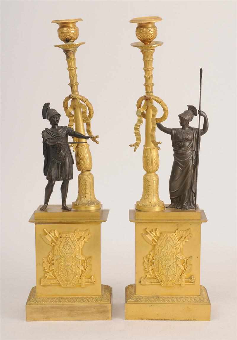 Appraisal: PAIR OF EMPIRE PATINATED AND GILT-BRONZE FIGURAL CANDLESTICKS Each modeled