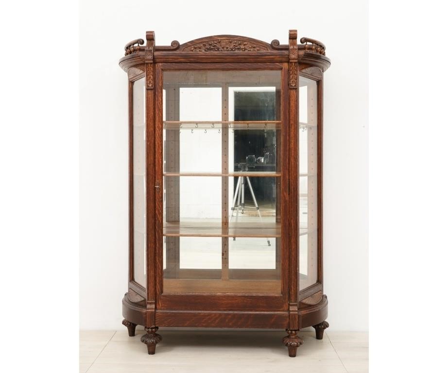 Appraisal: Oak china cabinet circa with carved oak leaves crest and