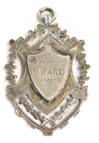 Appraisal: A silver shield fob with pierced outer design and central