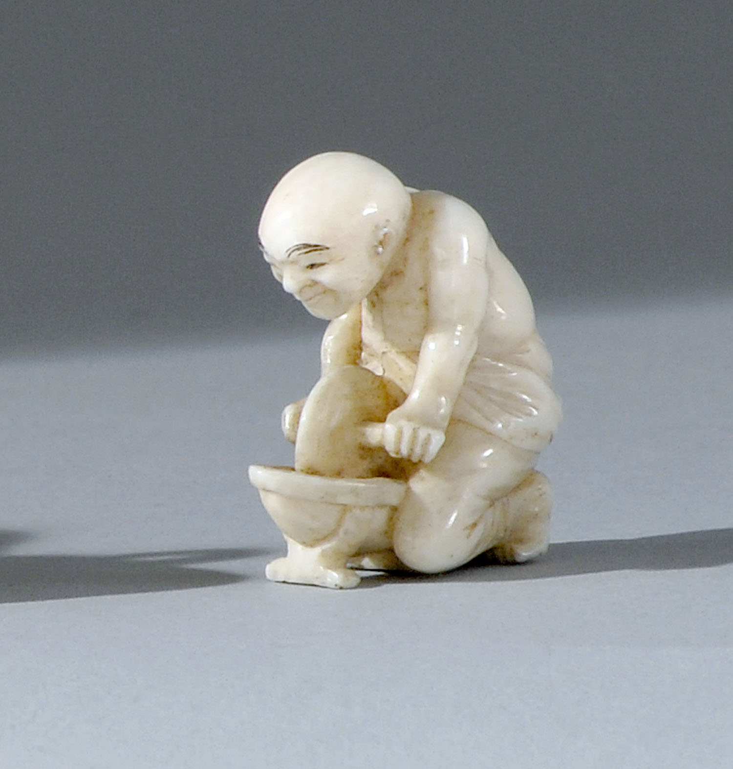 Appraisal: MINIATURE IVORY NETSUKE Late th CenturyIn the form of a