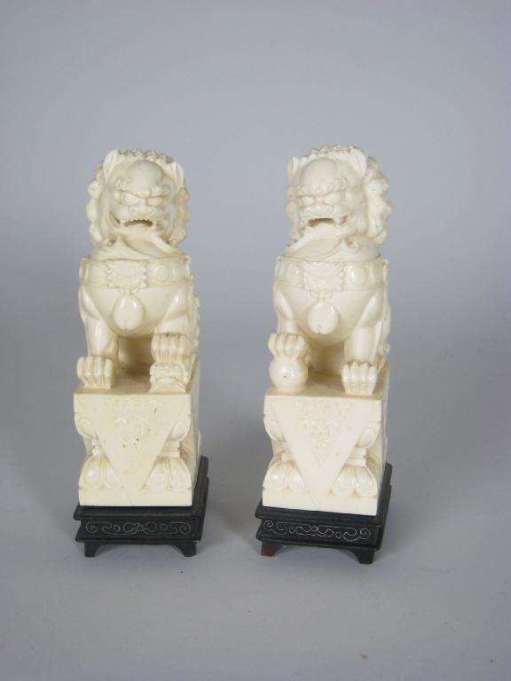 Appraisal: Pair of Chinese carved ivory Dogs of Fo in H