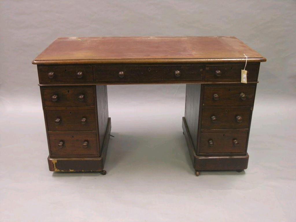 Appraisal: A Victorian walnut pedestal desk fitted with three frieze drawers