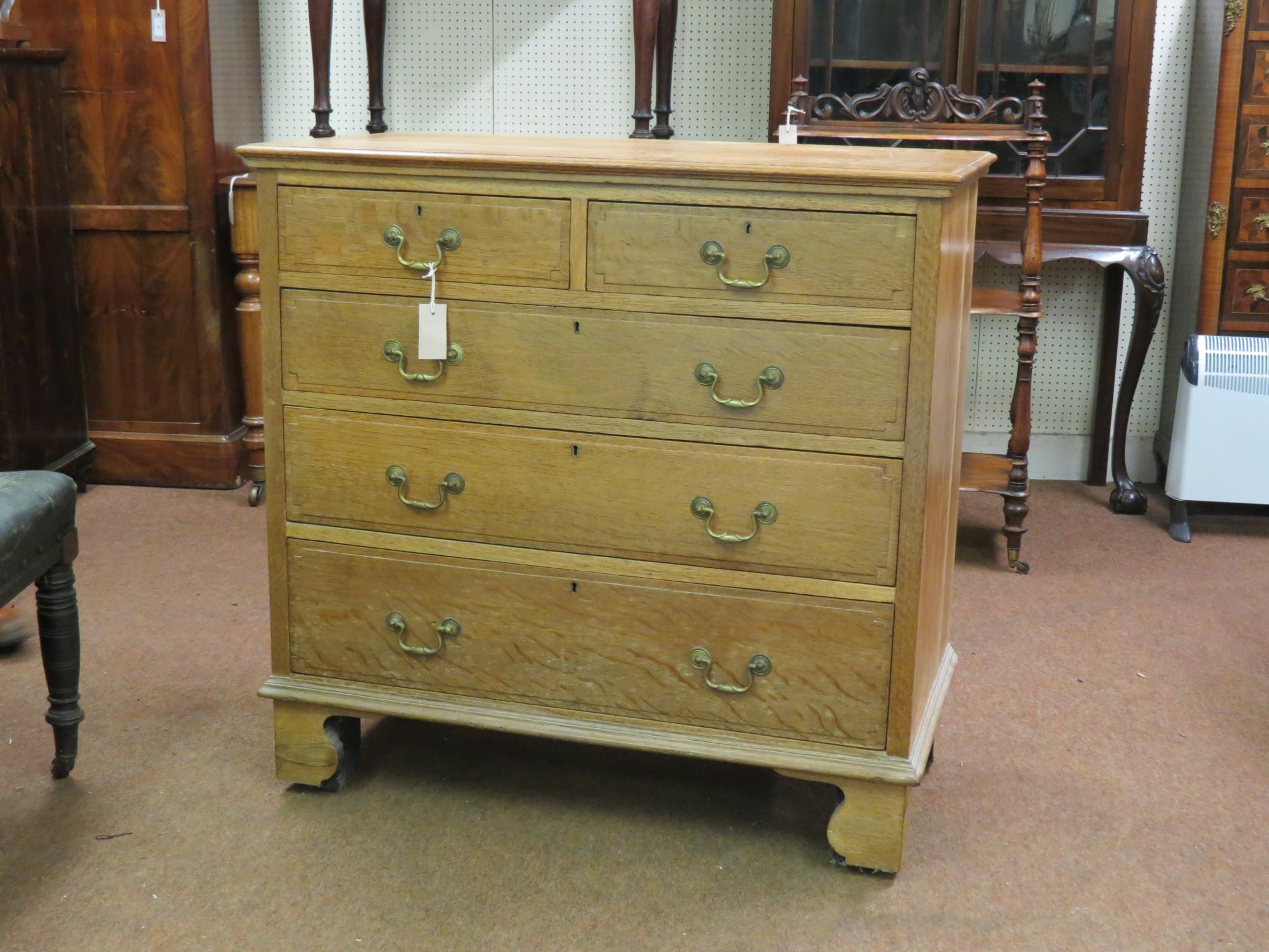 Appraisal: A solid light oak chest two short and three long