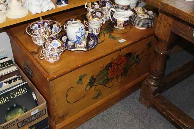 Appraisal: A VICTORIAN STRIPPED PINE BLANKET CHEST with painted floral decoration