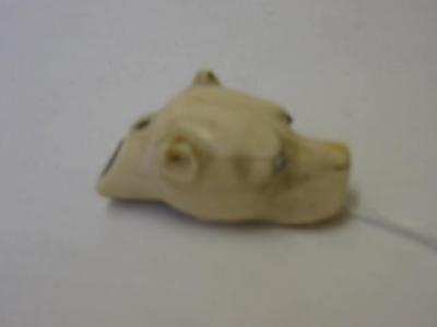 Appraisal: A LATE VICTORIAN IVORY WHISTLE modelled as a dog's head