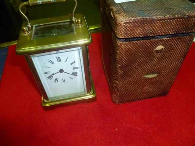 Appraisal: A BRASS CARRIAGE CLOCK with swing handle enamel dial and