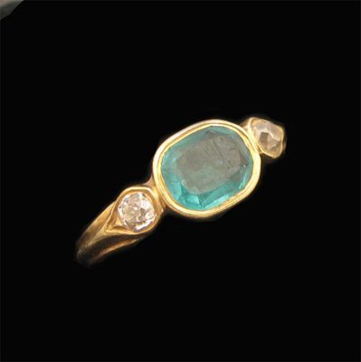 Appraisal: A Victorian emerald and diamond three stone ring the oval