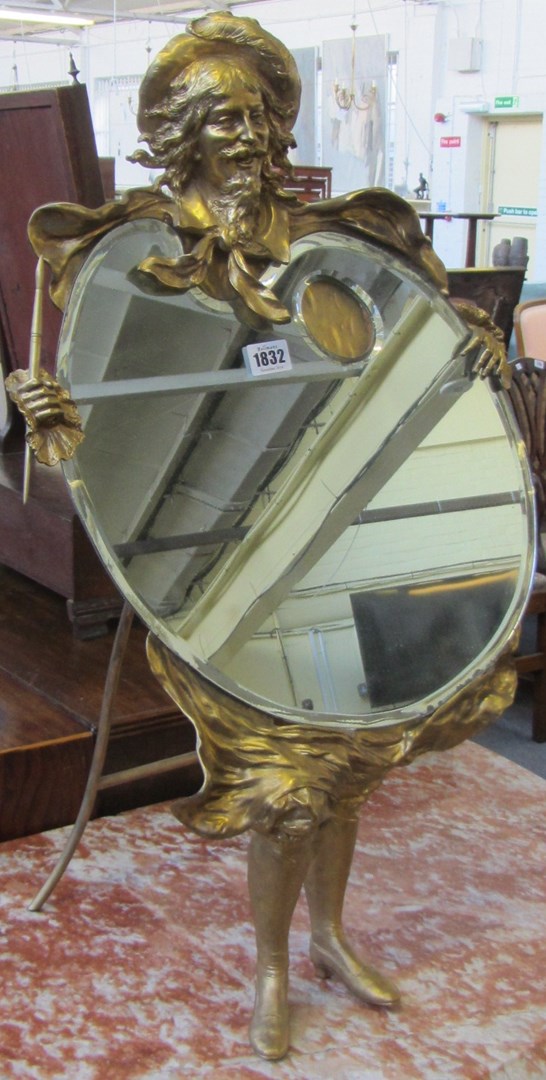 Appraisal: A gilt bronze figural mirror early th century modelled as