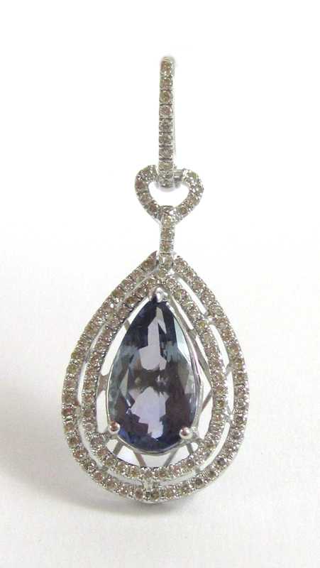 Appraisal: TANZANITE AND FOURTEEN KARAT WHITE GOLD PENDANT with round-cut diamonds