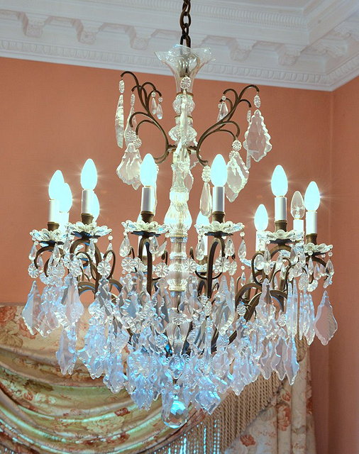 Appraisal: A LARGE METAL TWELVE BRANCH CHANDELIER with shaped glass drops