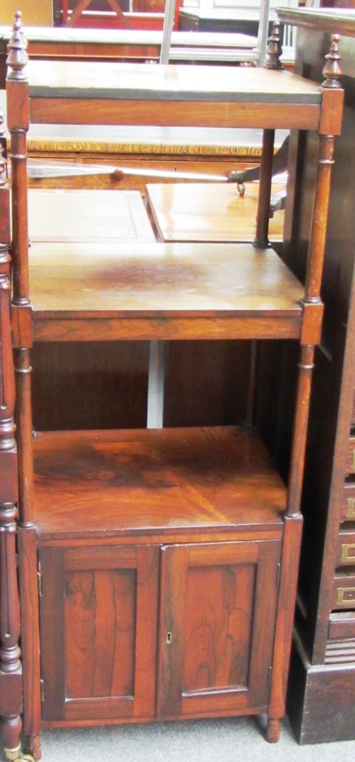 Appraisal: A th century rosewood three tier whatnot with double cupboard