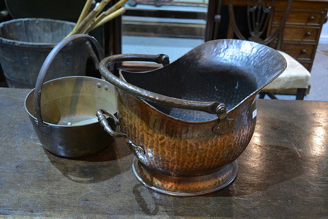 Appraisal: A copper helmet shaped coal scuttleand a brass jam pan