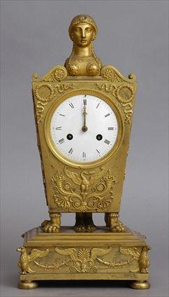 Appraisal: EMPIRE GILT-BRONZE MANTEL CLOCK The in enameled dial within a