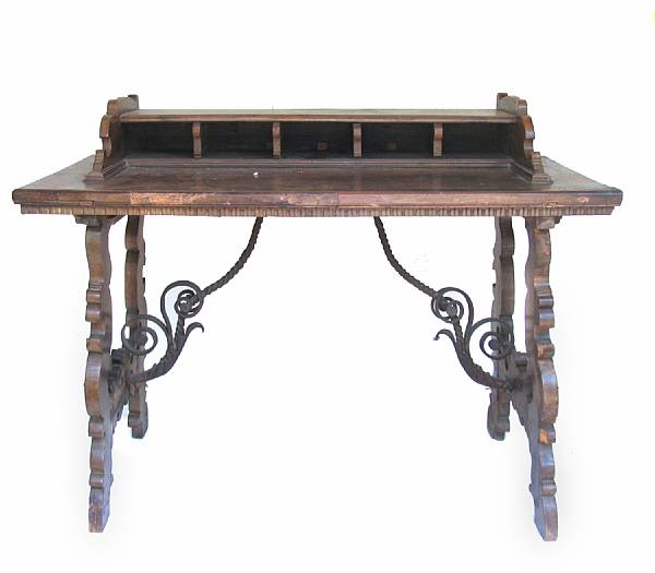 Appraisal: A Spanish Baroque style desk with wrought metal supports partially