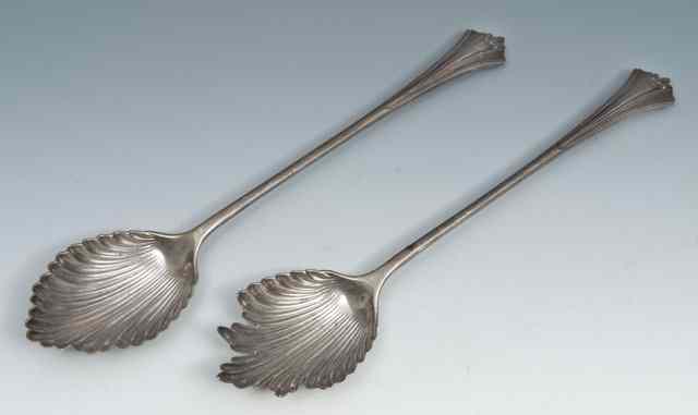 Appraisal: A PAIR OF VICTORIAN SILVER SALAD SERVERS with shell shaped