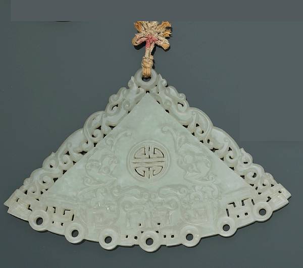 Appraisal: A reticulated jade pendant Thinly sectioned as a musical chime