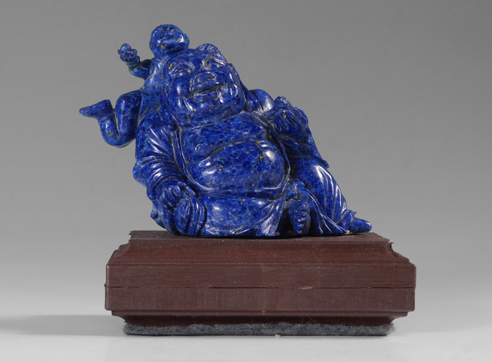 Appraisal: CARVED CHINESE LAPIS LAZULI BUDDHA ATTENDANT Figure of a seated