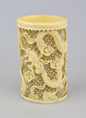 Appraisal: A Japanese th century ivory reticulated cylindrical brush holder carved