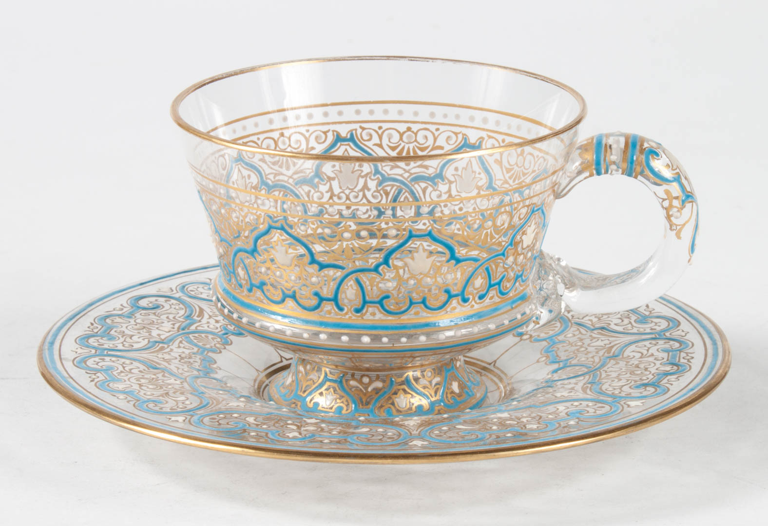 Appraisal: Moser enameled glass teacup and saucer early th century raised