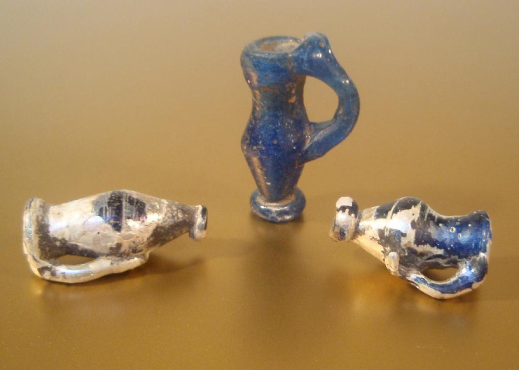 Appraisal: Three late Roman blue glass juglet pendants partial iridescent weathering