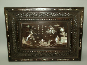 Appraisal: A Chinese rectangular hardwood panel with scroll pierced border and