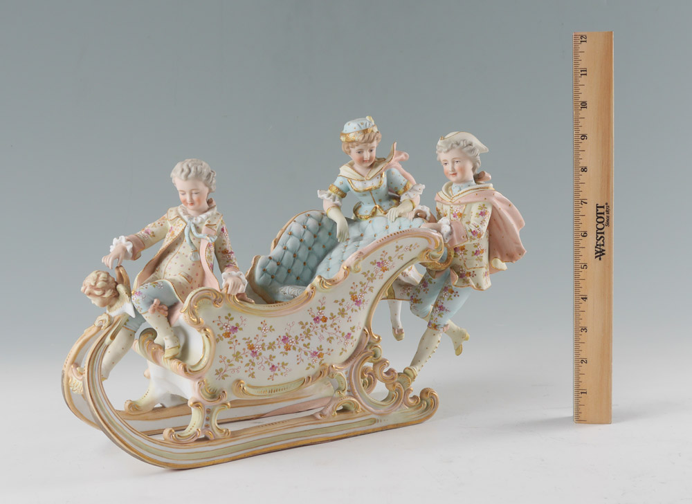 Appraisal: BISQUE SLED FIGURAL GROUP figures on sled with floral decoration