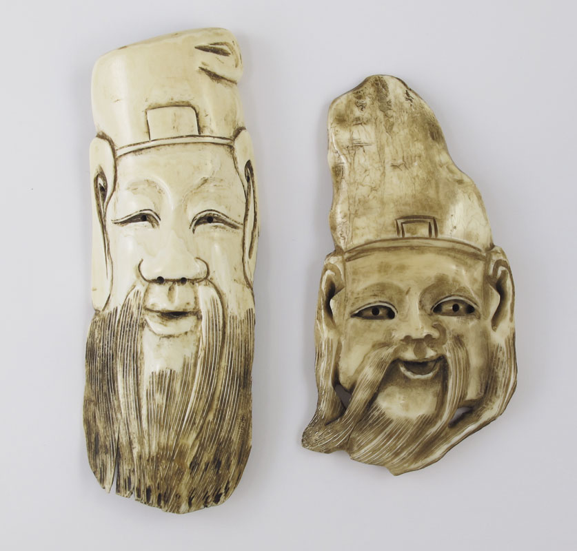 Appraisal: CARVED IVORY FACES OF CHINESE MEN Carved and pierced from