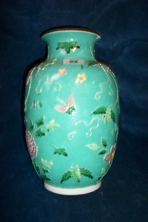 Appraisal: A green ground oriental vase with relief moulded and painted