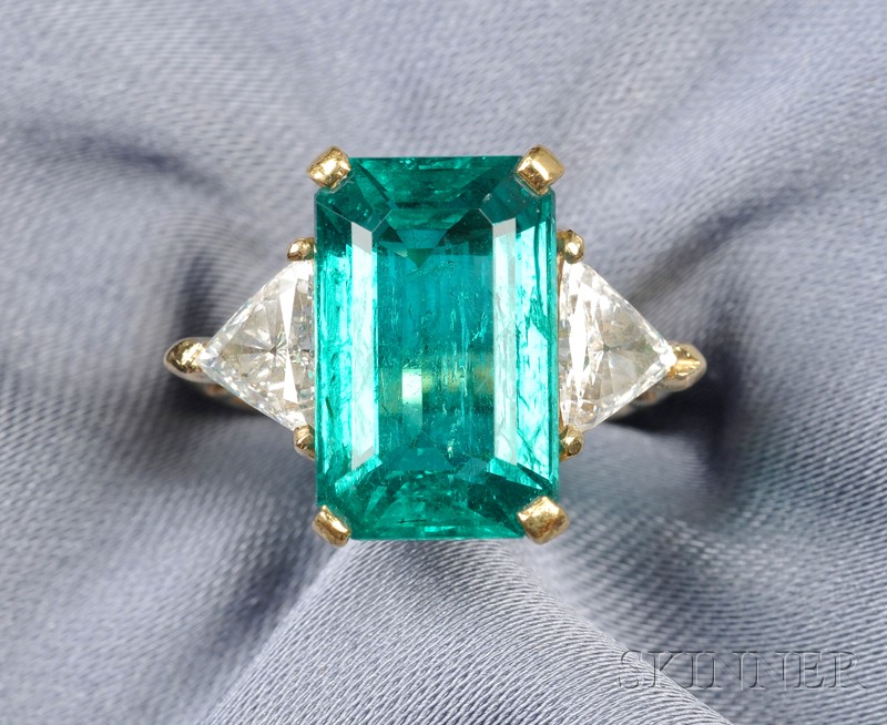 Appraisal: Emerald and Diamond Ring prong-set with an emerald-cut emerald measuring