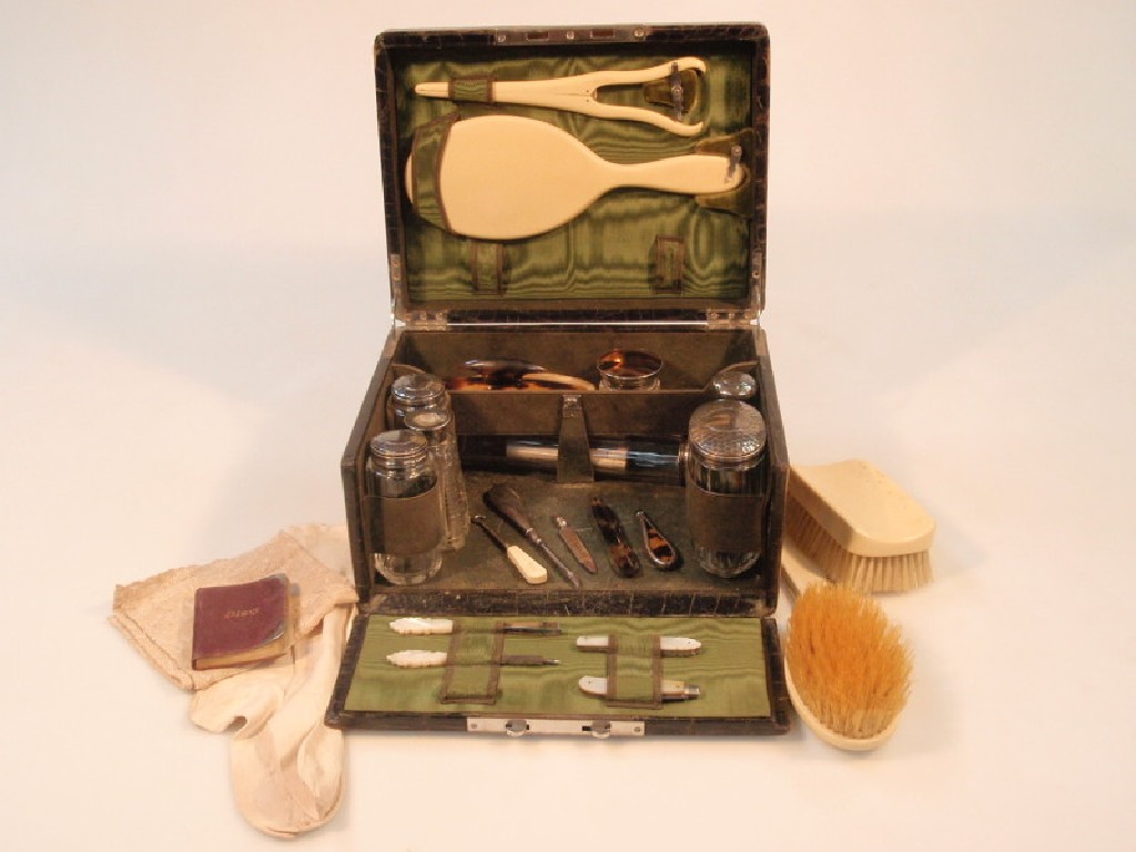 Appraisal: An Edward VII crocodile effect leather covered vanity case lined