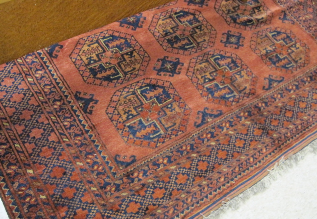 Appraisal: AFGHAN ERSARI CARPET featuring three columns of seven octagonal Ersari