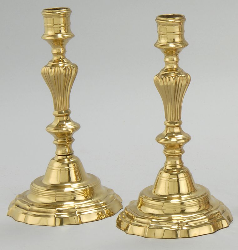 Appraisal: PAIR OF FRENCH EMPIRE-STYLE BRASS CANDLESTICKS With ribbed shaft and