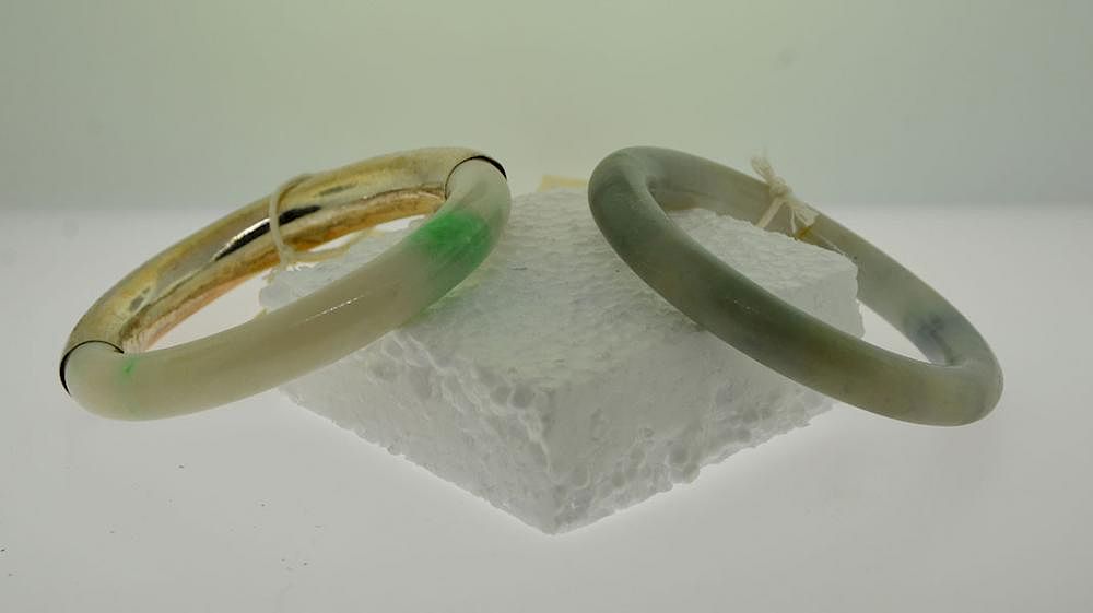 Appraisal: Two Jade Bangles Two jade bangle bracelets one white with