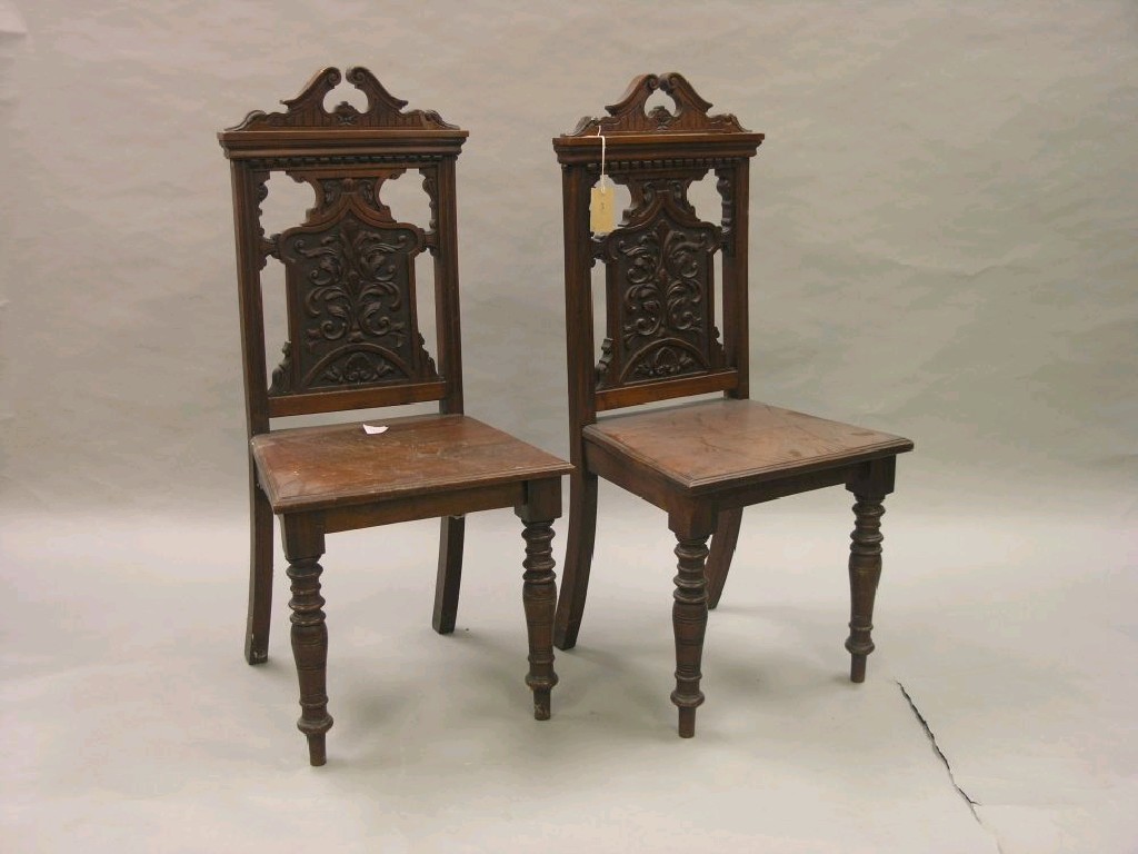 Appraisal: A pair of late Victorian walnut hall chairs each back