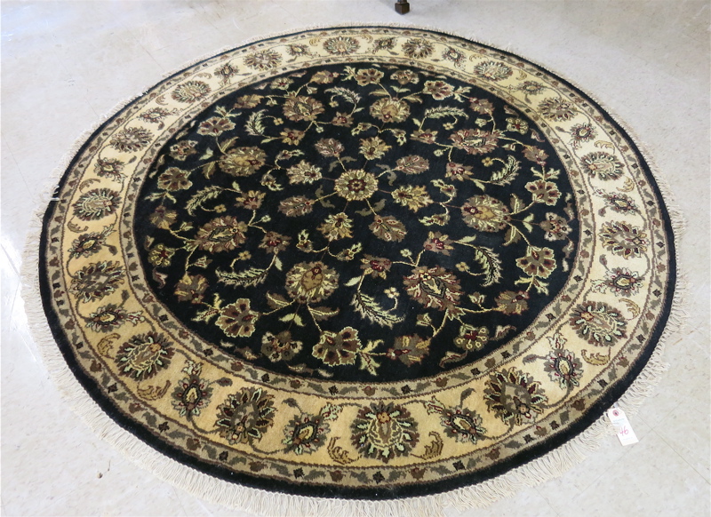 Appraisal: A ROUND ORIENTAL ACCENT RUG Indo-Persian hand knotted in an