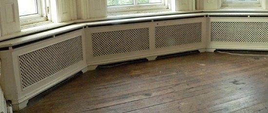 Appraisal: A triple pierced cast radiator surround with marble top on