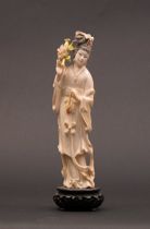 Appraisal: Carved Ivory Figure with Flowers Delicately carved ivory figure depicts