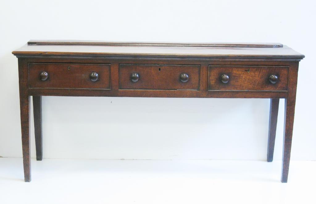 Appraisal: An antique oak Dresser Base with three frieze drawers on