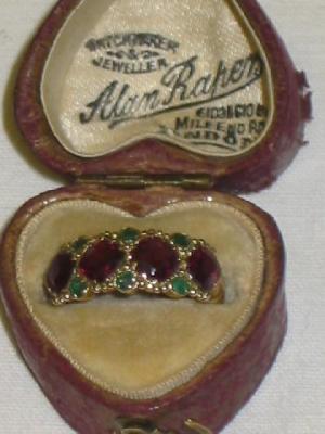 Appraisal: A GARNETT AND EMERALD RING comprising four cushion cut garnets