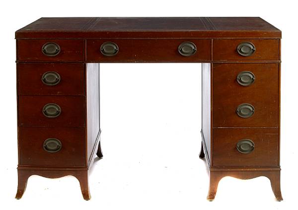 Appraisal: A George II style mahogany leather topped kneehole desk and